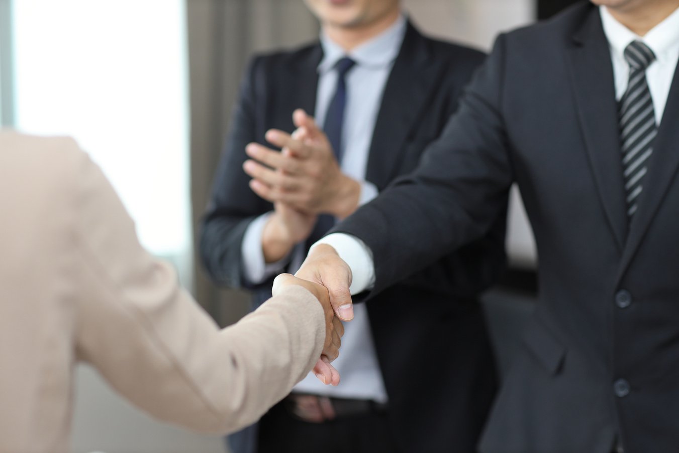 Close up image of business happy people shaking hands meaning of introduction, greeting, success negotiation or finishing up meeting. Gesturing connection deal concept.